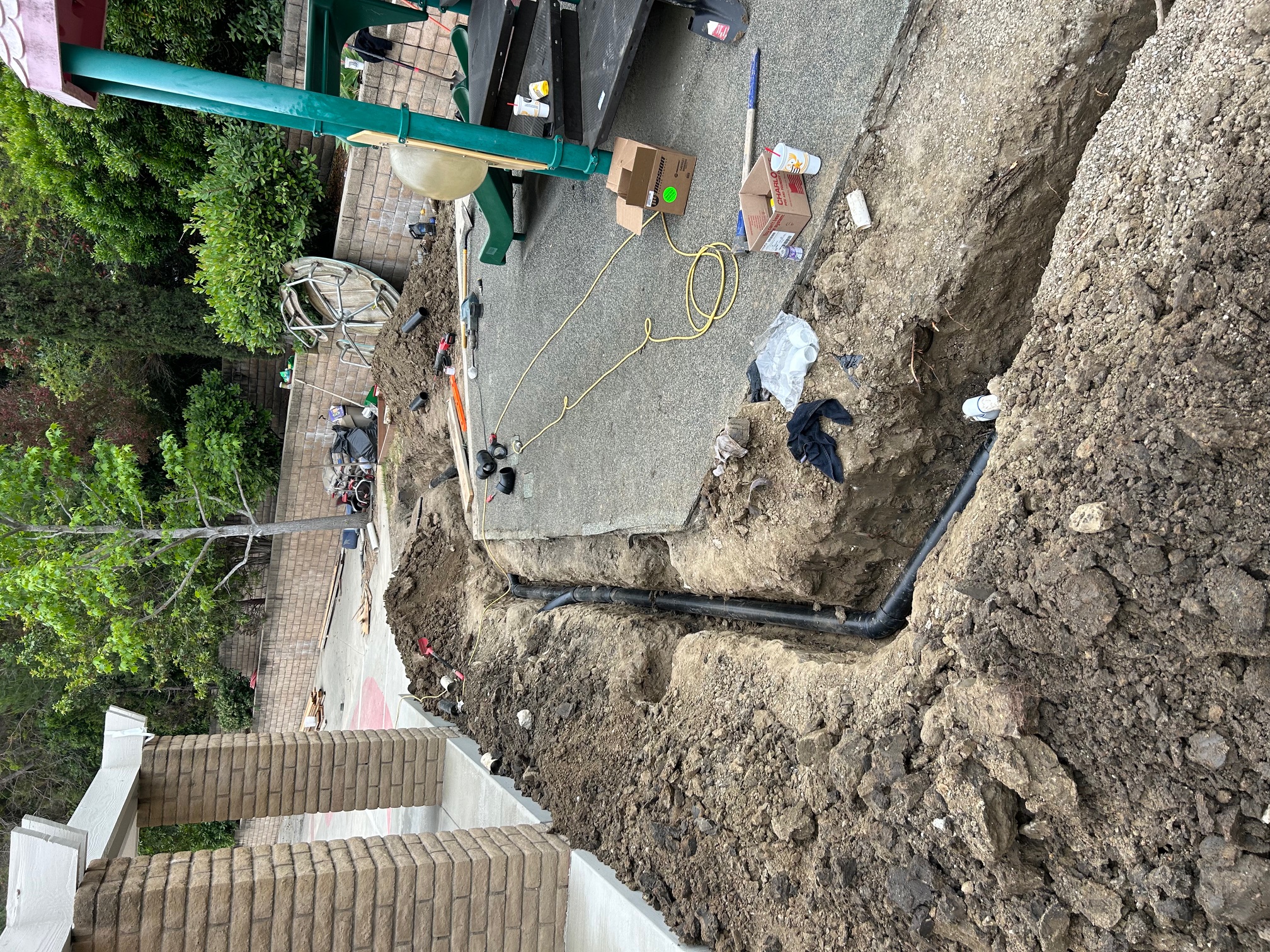 Trenching for new underground plumbing pipes