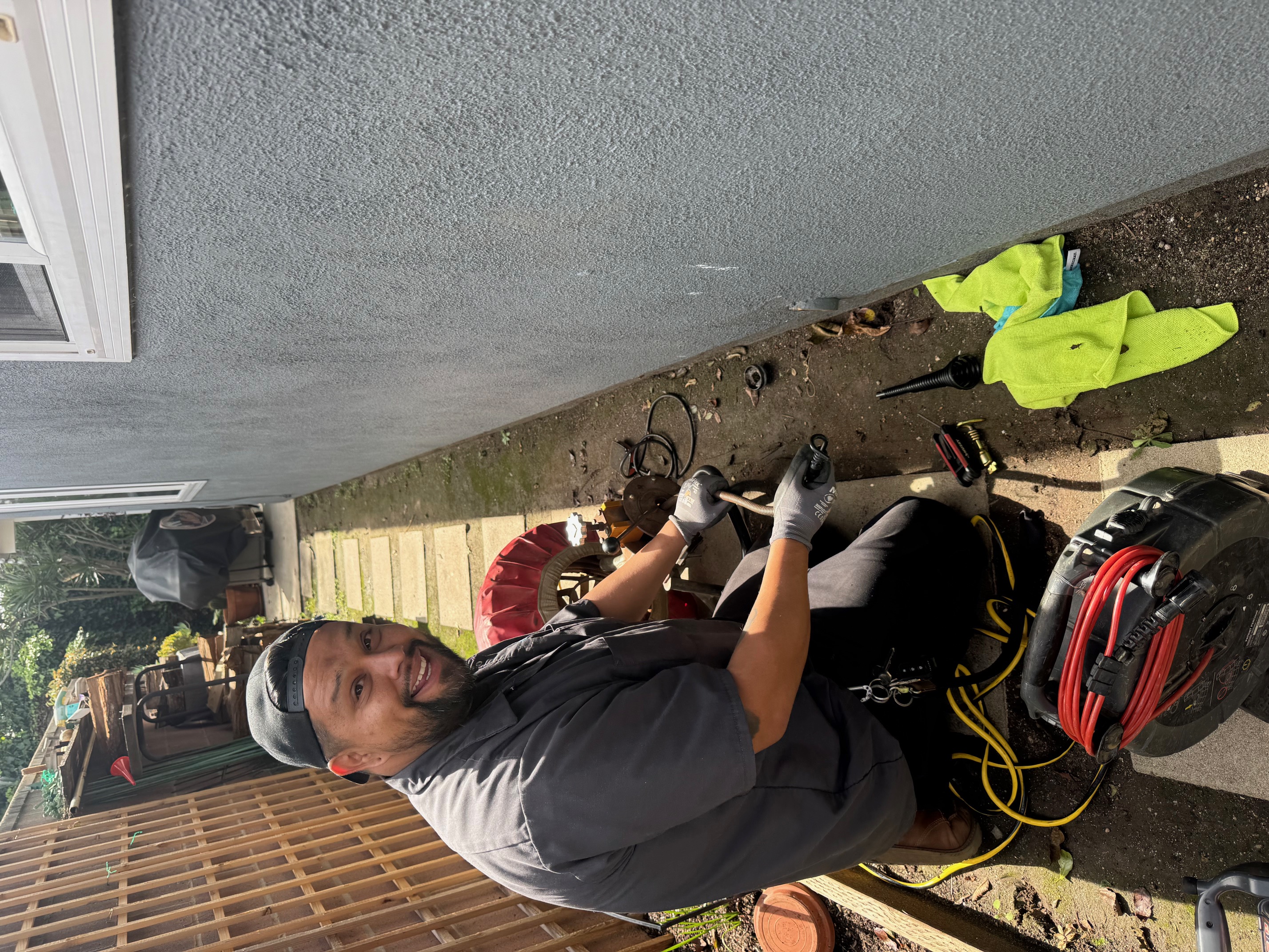 Coastline Plumbing technician working on exterior pipes in Orange County